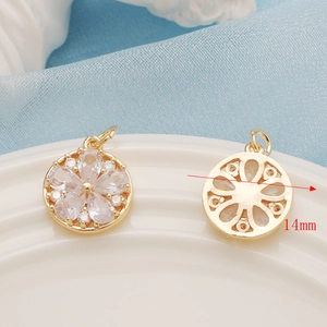 Macro detail of 14mm 14K gold plated flower pendant with cubic zirconia inlay front and back