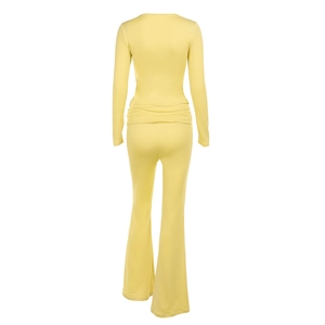 Rear view of yellow square neck long sleeve top and flare pants set with ruched texture