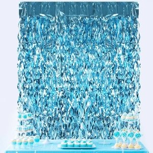 Close-up of metallic blue foil fringe curtain with shimmering wave texture for parties