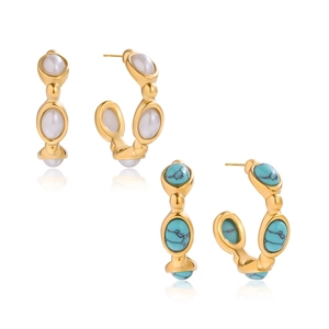 Gold titanium steel C-shape earrings with turquoise and white pearls in studio lighting