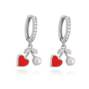 Detail of silver cherry earrings with red heart-shaped stones and pearls in close-up