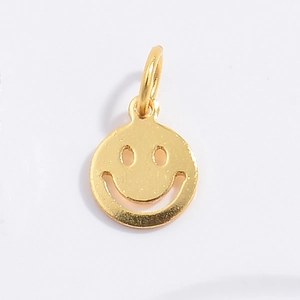 Close-up of golden S925 silver round smiley face pendant with hollow design and ring loop