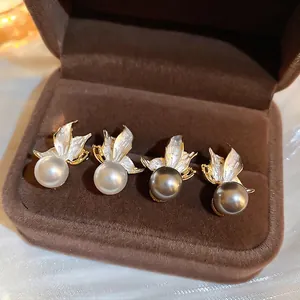 Elegant butterfly pearl stud earrings set in white and grey colors on velvet tray