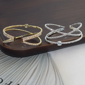 Detail of luxury rhinestone zircon crossover open bangles in gold and silver finish