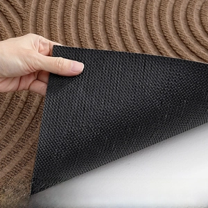 Detail of non-slip rubber backing and thick brown spiral texture on entry door mat