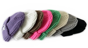 Close-up of 8 candy-colored knitted beanies showing texture and R letter embroidery
