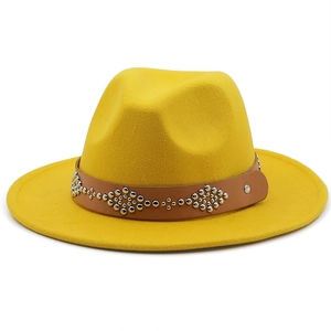 Detail of yellow wool fedora hat featuring a brown leather band with silver metal rivets