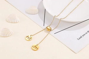 Detailed macro view of gold heart slider and family silhouette pendants on necklace