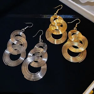 Metallic circular layered tassel drop earrings in gold and silver finish with ear hooks