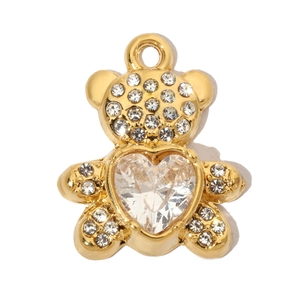 Detailed macro view of a golden bear pendant with a heart-shaped cubic zirconia stone