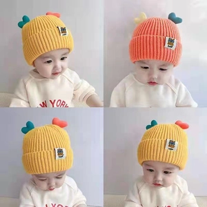 Cute knitted baby fisherman hat with heart decoration in yellow and orange colors