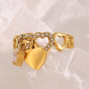 Detail of 18K gold plated heart ring featuring a crystal and hollow heart pendant
