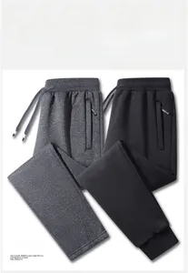 Flat lay of men's casual joggers in dark grey and black with drawstring waist