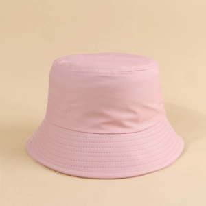 Detail of pink cotton bucket hat featuring reinforced stitched brim and flat top design