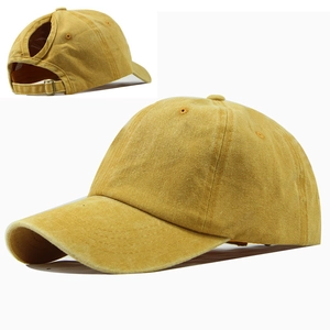 Detail of mustard yellow washed cotton ponytail baseball cap with large back opening