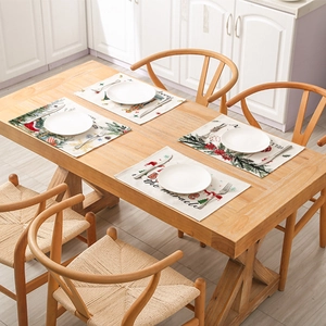 Set of 4 Christmas polyester placemats with festive prints on wooden dining table