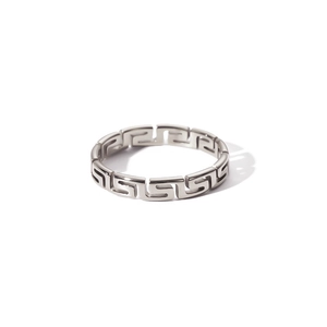 Macro detail of silver stainless steel ring featuring Greek meander pattern cutout design