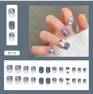 Blue gradient press-on nails with white 3D bows and pearl accents in short square shape