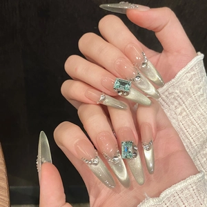Cat eye press-on nails with emerald square gemstone and sparkling diamond accents
