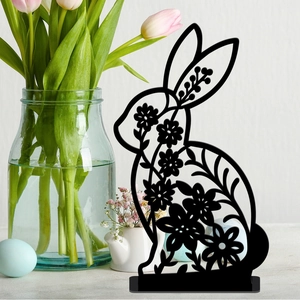 Detail of black rabbit silhouette with floral cutouts and Easter egg decorations