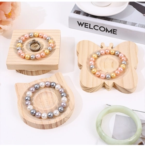 Detail of creative butterfly and cat shaped wooden jewelry display trays for bracelets