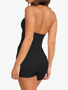 Close-up of the backless halter design on this black athletic yoga two-piece set for women