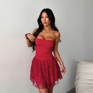 Detailed close-up of the red strapless dress featuring ruffled bodice and layered lace hem