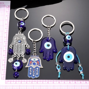 Bohemian Hamsa Hand and Evil Eye keychain set with blue glass and tassel charms