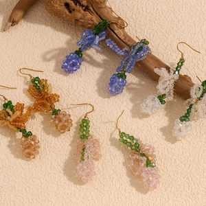 Detailed view of handmade crystal bead drop earrings in various pastel colors with gold hooks
