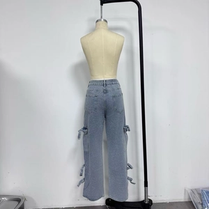 Detail view of light blue cargo jeans showing rear patch pockets and denim texture
