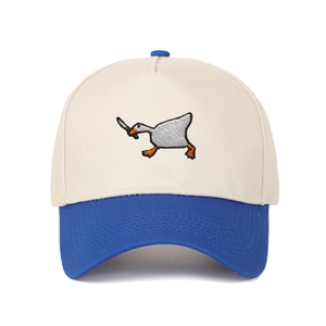 Close-up of goose with knife embroidery on a two-tone beige and blue baseball cap