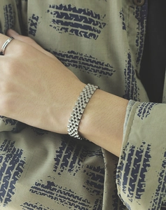 Close-up of a silver titanium steel men's watchband bracelet worn on a model's wrist
