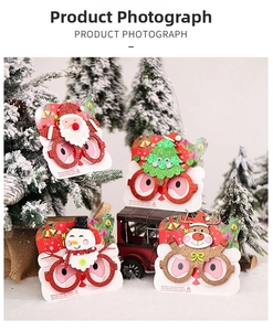 Detail showing set of 4 glittery Christmas glasses with Santa, Snowman, Tree, and Reindeer themes