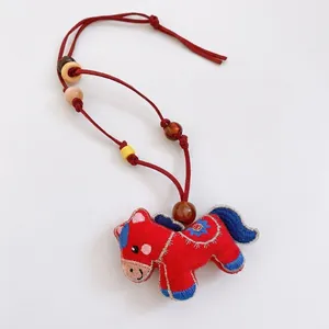 Embroidered red felt horse pendant necklace with colorful wooden beads on a cord