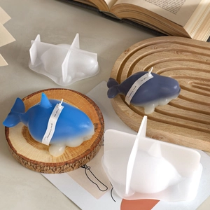 Orca whale silicone candle mold set with finished gradient candles on wooden tray