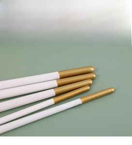 Close-up of waterproof birch wood penholders with white and gold lacquered finish