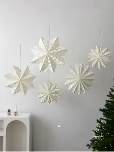 Set of 5 white paper star ornaments with intricate cut-out patterns for holiday decor
