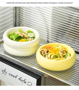 Close-up of ceramic donut bowl with fresh chicken salad on modern glass stand