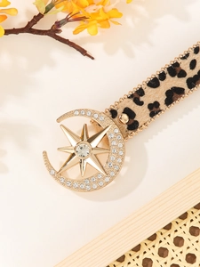 Detail of leopard print belt with rhinestone moon star buckle and gold chain trim