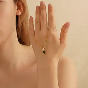 Vintage gold necklace featuring round white zircon and pear-shaped green birthstone pendant