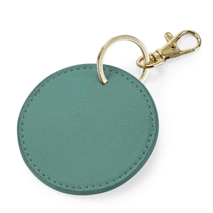 Detail of round teal faux leather keychain with gold hardware and fine cross grain texture