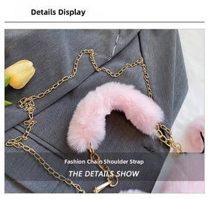 Detail of pink faux fur shoulder strap and golden metal chain for heart-shaped bag