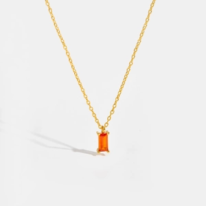 Macro detail of rectangle orange gemstone pendant on a gold S925 silver chain