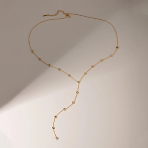 Detail of 18k gold plated Y-necklace with sparkling diamonds and secure lobster clasp