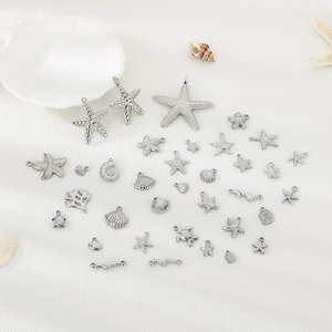 Silver stainless steel ocean charms set featuring starfish, shells, and sea turtles
