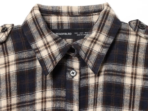 Macro detail of the classic plaid shirt collar and shoulder epaulette on this long dress