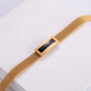 Golden titanium steel woven mesh bracelet with Greek key pattern detail on black inlay
