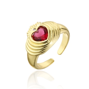 Detail of 18K gold ring featuring a red heart-shaped zircon and a sparkling small diamond