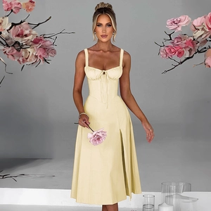 Detail of slim fit pale yellow strap dress with waist tie and side slit detail