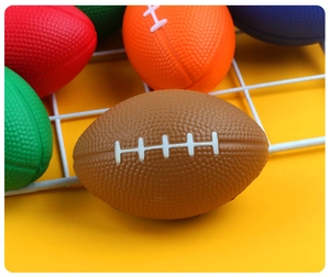 Macro shot of colorful mini foam rugby balls with non-slip texture on yellow background